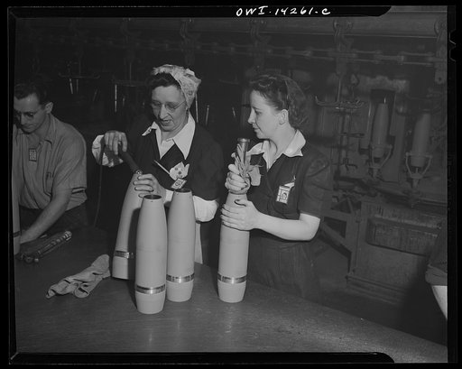 Detroit, Michigan. Steps in the maufacture of casings for 105 mm. shells in the Budd wheel plant. Women inspecting shell before packing