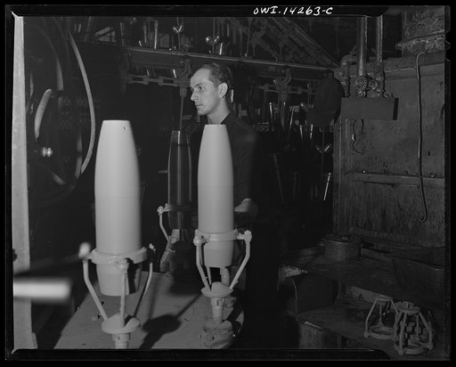 Detroit, Michigan. Steps in the maufacture of casings for 105 mm. shells in the Budd wheel plant. Painting a shell inside and out