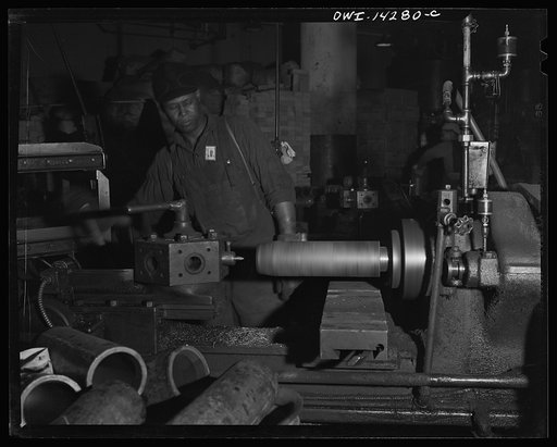 Untitled photo, possibly related to: Detroit, Michigan. Steps in the manufacture of casings for 105 mm. shells in the Budd wheel plant. Centering the shell forging. Beginning operations of machine work