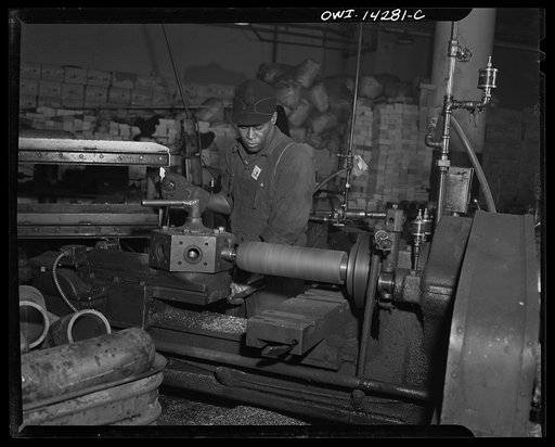 Detroit, Michigan. Steps in the manufacture of casings for 105 mm. shells in the Budd wheel plant. Centering the shell forging. Beginning operations of machine work