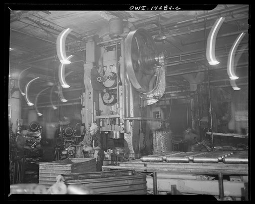 Detroit, Michigan. Steps in the manufacture of casings for 105 mm. shells in the Budd wheel plant. Huge machines used to cold nose rough turned shells