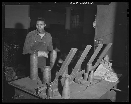 Detroit, Michigan. Steps in the manufacture of casings for 105 mm. shells in the Budd wheel plant. Shot blasting the inside of a shell