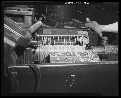 Detroit, Michigan. Steps in the manufacture of casings for 105 mm. shells in the Budd wheel plant. Rough turning a shell showing lubrication liquid