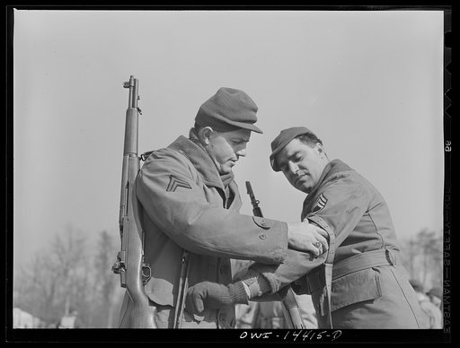 Fort Belvoir, Virginia. Corporal adjusting a rifle sling for Sergeant Biviano