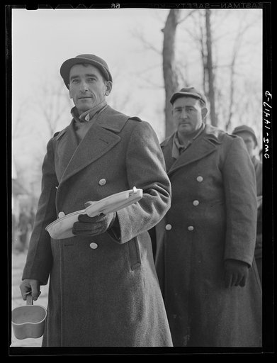 Fort Belvoir, Virginia. Soldier of Italian descent waiting with his mess kit for noon "chow"
