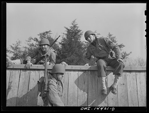 Fort Belvoir, Virginia. Privates Chirico and Dalto and Sergeant Tauro scaling a fence on the obstacle course