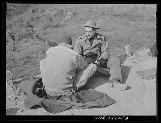 Fort Belvoir, Virginia. Daniel Masciolli on the rifle range coaching a soldier who is learning how to shoot