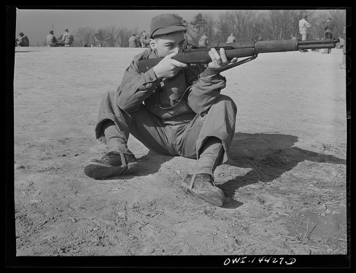 Untitled photo, possibly related to: Fort Belvoir, Virginia. Private Paul Tellinin loading his gun