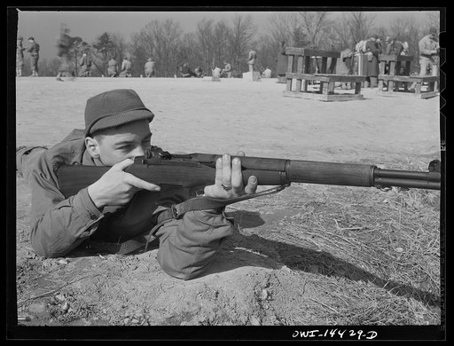 Untitled photo, possibly related to: Fort Belvoir, Virginia. Private Paul Tellinin loading his gun