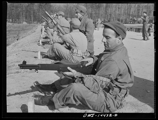 Fort Belvoir, Virginia. Private Paul Tellinin loading his gun