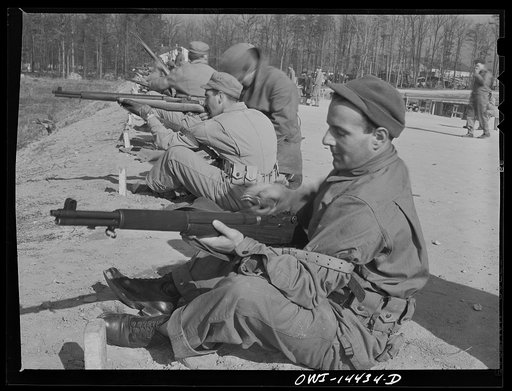 Untitled photo, possibly related to: Fort Belvoir, Virginia. Private Paul Tellinin loading his gun