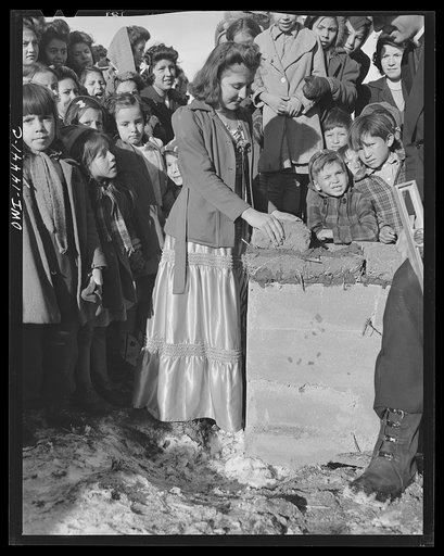 Untitled photo, possibly related to: Penasco, New Mexico. Laying the corner adobe of the new building for the clinic operated by the Taos County cooperative health association