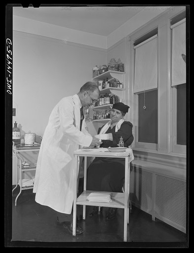New York, New York. Italian surgeon bandaging a patient's arm