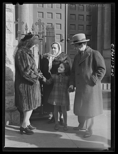 New York, New York. Italian family on the steps of a Catholic church in the Bronx after mass on Sunday