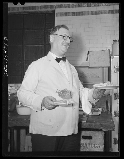 New York, New York. A waiter in John's Restaurant on East Twelfth Street