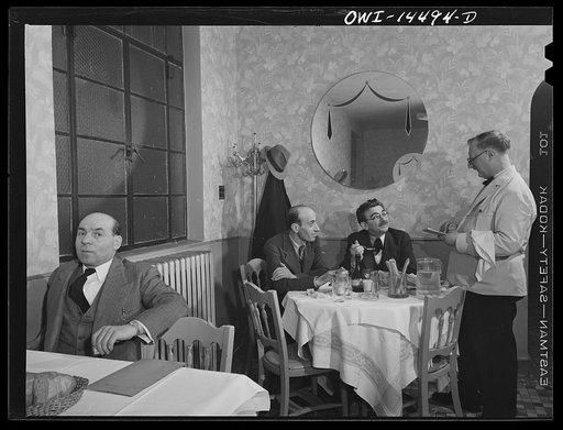 New York, New York. John's Restaurant on Twelfth Street near Second Avenue is a haunt of Italian journalists and intellectuals. At the rear table, with glasses, is Girolamo Valente, editor of La Parola