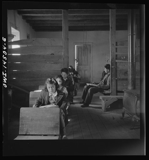 Untitled photo, possibly related to: Ojo Sarco, New Mexico. One-room school in an isolated mountainous Spanish-American community, which has eight grades and two teachers. Most of the teaching is in Spanish, the language spoken in the children's homes, and as a result they rarely speak English fluen