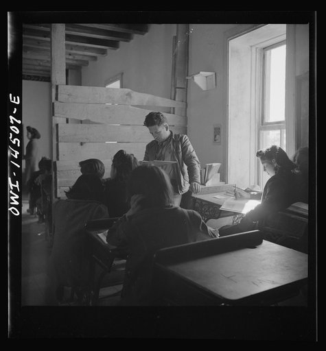 Ojo Sarco, New Mexico. One-room school in an isolated mountainous Spanish-American community, which has eight grades and two teachers. Most of the teaching is in Spanish, the language spoken in the children's homes, and as a result they rarely speak English fluently