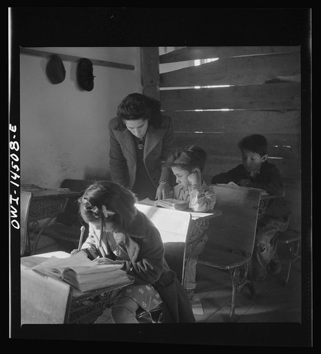 Ojo Sarco, New Mexico. One-room school in an isolated mountainous Spanish-American community, which has eight grades and two teachers. Most of the teaching is in Spanish, the language spoken in the children's homes, and as a result they rarely speak English fluently