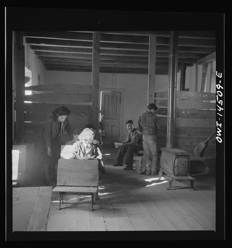 Untitled photo, possibly related to: Ojo Sarco, New Mexico. One-room school in an isolated mountainous Spanish-American community, which has eight grades and two teachers. Most of the teaching is in Spanish, the language spoken in the children's homes, and as a result they rarely speak English fluen