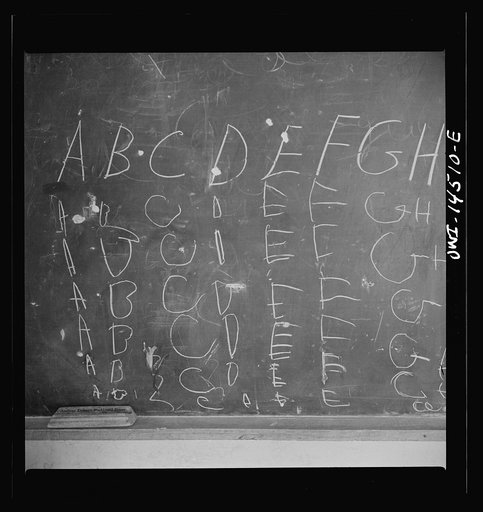 Ojo Sarco, New Mexico. One-room school in an isolated mountainous Spanish-American community, which has eight grades and two teachers. The teachers have little equipment with which to work and the ABCs, penmanship, and grammar are taught on the blackboard