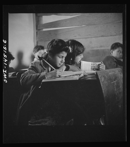 Untitled photo, possibly related to: Ojo Sarco, New Mexico. One-room school in an isolated mountainous Spanish-American community, which has eight grades and two teachers. Most of the teaching is in Spanish, the language spoken in the children's homes, and as a result they rarely speak English fluen