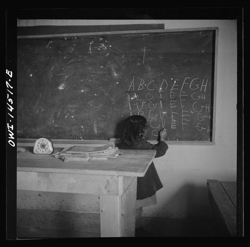 Ojo Sarco, New Mexico. One-room school in an isolated mountainous Spanish-American community, which has eight grades and two teachers. The teachers have little equipment with which to work and the ABCs, penmanship, and grammar are taught on the blackboard