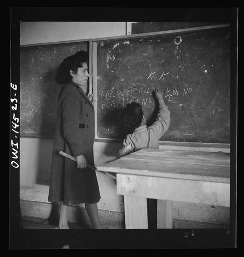 Ojo Sarco, New Mexico. One-room school in an isolated mountainous Spanish-American community, which has eight grades and two teachers. The teachers have little equipment with which to work and the ABCs, penmanship, and grammar are taught on the blackboard