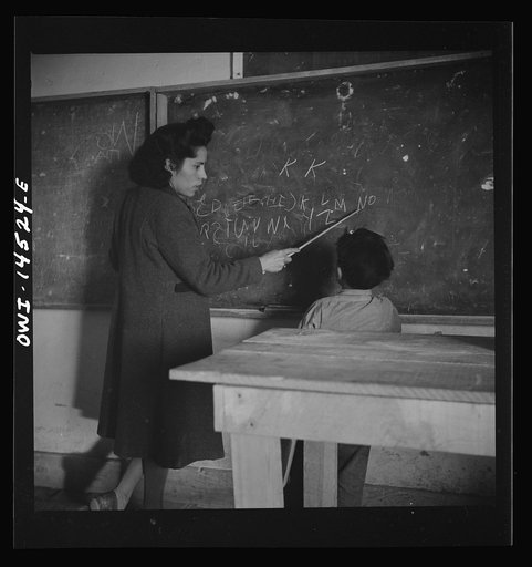 Ojo Sarco, New Mexico. One-room school in an isolated mountainous Spanish-American community, which has eight grades and two teachers. The teachers have little equipment with which to work and the ABCs, penmanship, and grammar are taught on the blackboard