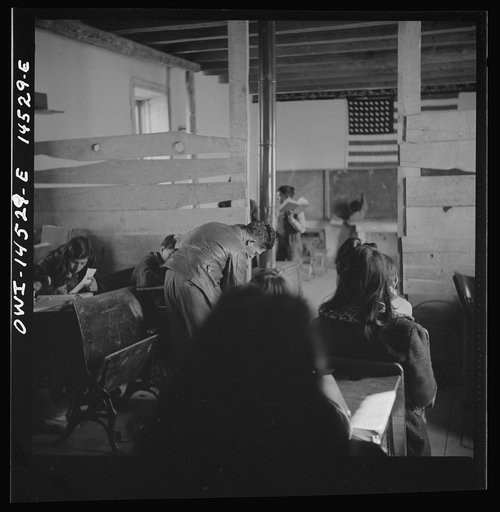 Untitled photo, possibly related to: Ojo Sarco, New Mexico. One-room school in an isolated mountainous Spanish-American community, which has eight grades and two teachers. Most of the teaching is in Spanish, the language spoken in the children's homes, and as a result they rarely speak English fluen