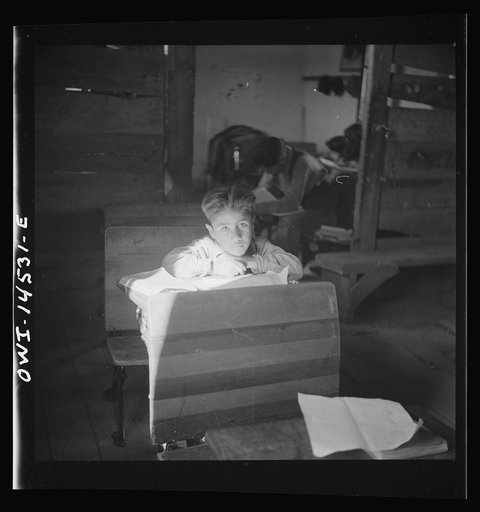 Untitled photo, possibly related to: Ojo Sarco, New Mexico. One-room school in an isolated mountainous Spanish-American community, which has eight grades and two teachers. Most of the teaching is in Spanish, the language spoken in the children's homes, and as a result they rarely speak English fluen