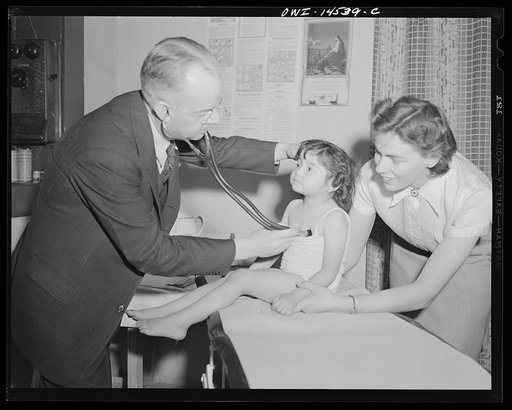 Penasco, New Mexico. Baby specialist making an examination on "well baby day" at the clinic operated by the Taos County cooperative health association