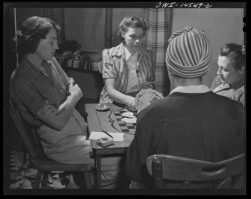 Penasco, New Mexico. Marjorie Muller, Red Cross resident nurse of the clinic operated by the Taos County cooperative health association, playing bridge at the United States forest ranger's house