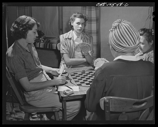 Untitled photo, possibly related to: Penasco, New Mexico. Marjorie Muller, Red Cross resident nurse of the clinic operated by the Taos County cooperative health association, playing bridge at the United States forest ranger's house