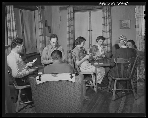 Penasco, New Mexico. Marjorie Muller, Red Cross resident nurse of the clinic operated by the Taos County cooperative health association, playing bridge at the United States forest ranger's home