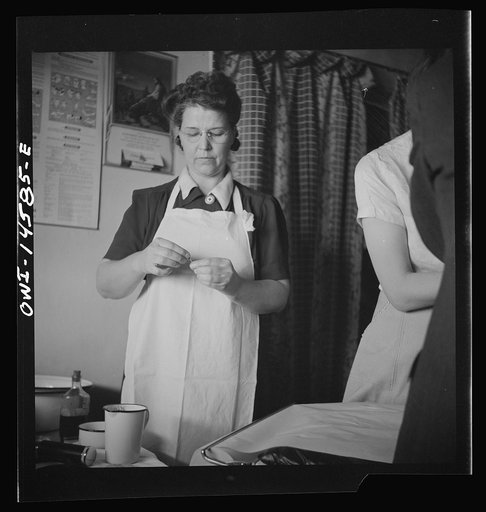 Penasco, New Mexico. Taos County public health nurse assisting in the clinic