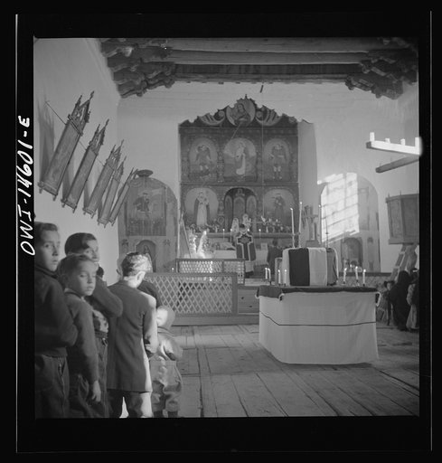 Untitled photo, possibly related to: Trampas, New Mexico. Father Cassidy conducting mass at a church which was built in 1700 and is the best-preserved colonial mission in the Southwest