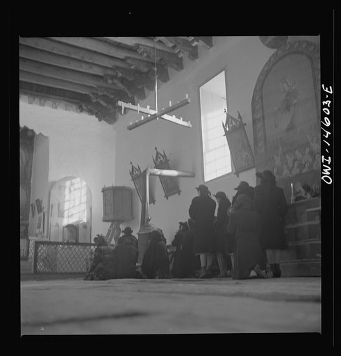 Untitled photo, possibly related to: Trampas, New Mexico. Father Cassidy conducting mass at a church which was built in 1700 and is the best-preserved colonial mission in the Southwest