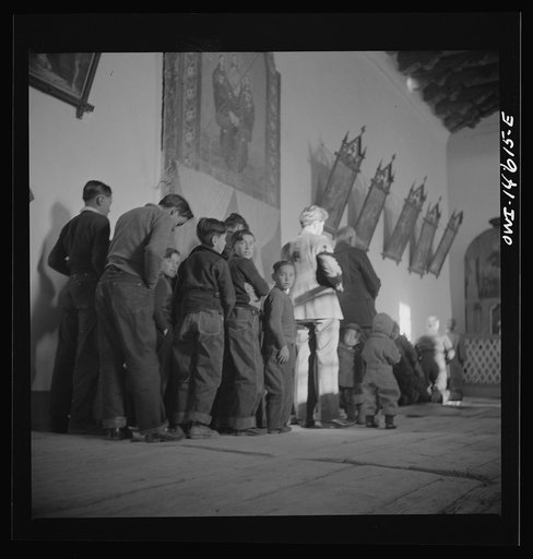 Untitled photo, possibly related to: Trampas, New Mexico. Father Cassidy conducting mass at a church which was built in 1700 and is the best-preserved colonial mission in the Southwest