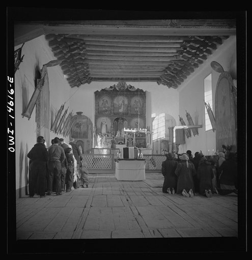Trampas, New Mexico. Memorial mass at a church which was built in 1700 and is the best-preserved colonial mission in the Southwest. Altar in the center is a symbolic coffin