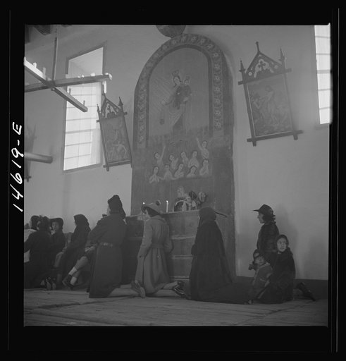 Untitled photo, possibly related to: Trampas, New Mexico. Service at the mission church. The painting on the retablo represents Nuestra Senora del Carmel