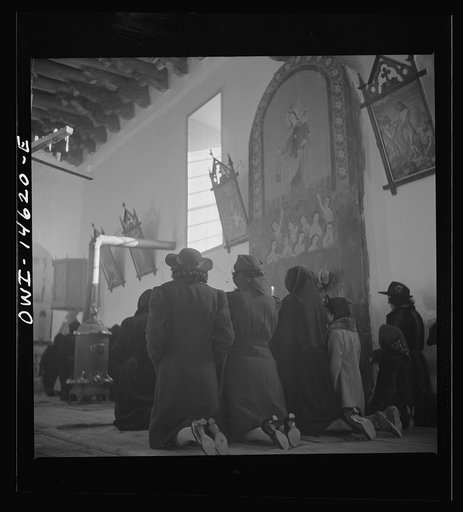 Untitled photo, possibly related to: Trampas, New Mexico. Service at the mission church. The painting on the retablo represents Nuestra Senora del Carmel