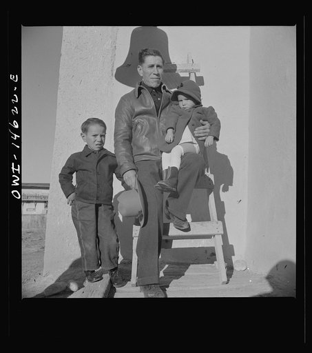 Untitled photo, possibly related to: Trampas, New Mexico. The bell "Gracia" on the left side of the entrance into the church