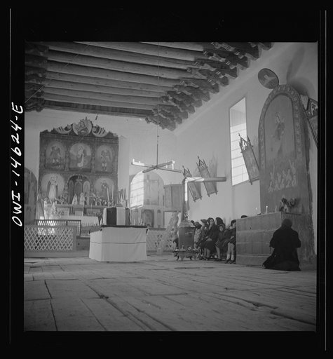 Untitled photo, possibly related to: Trampas, New Mexico. Service at the mission church. The painting on the retablo represents Nuestra Senora del Carmel