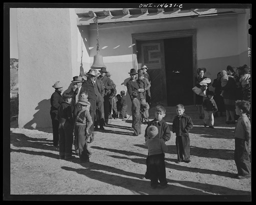 Untitled photo, possibly related to: Trampas, New Mexico. Congregation leaving after mass from a church which was built in 1700 and is the best-preserved colonial mission in the Southwest
