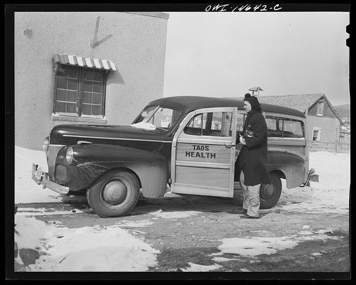 Untitled photo, possibly related to: Penasco, New Mexico. Nurse Marjorie Muller, of the clinic operated by the Taos County cooperative health association, starting out on a call