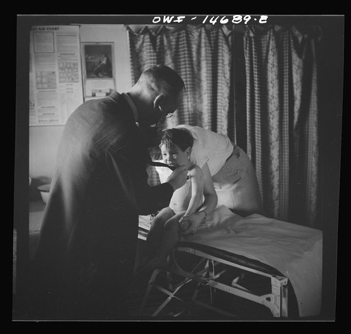 Untitled photo, possibly related to: Penasco, New Mexico. Doctor Onstine making an examination in the clinic operated by the Taos County cooperative health association
