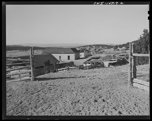 Ojo Sarco, New Mexico. Ojo Sarco valley is scattered with villages which have grown up around one family. The land is re-divided until its owners are forced to go elsewhere to make cash, while their families remain at home. In the distance is the valley of the Rio Grande