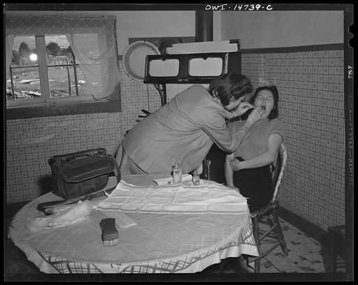 Llano Quemado (vicinity), New Mexico. Marjorie Muller, nurse from the clinic operated by the Taos County cooperative health association, making a home call