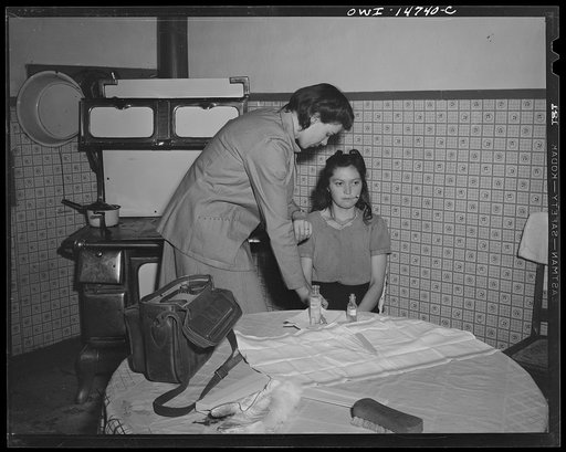 Llano Quemado (vicinity), New Mexico. Marjorie Muller, nurse from the clinic operated by the Taos County cooperative health association, making a home call